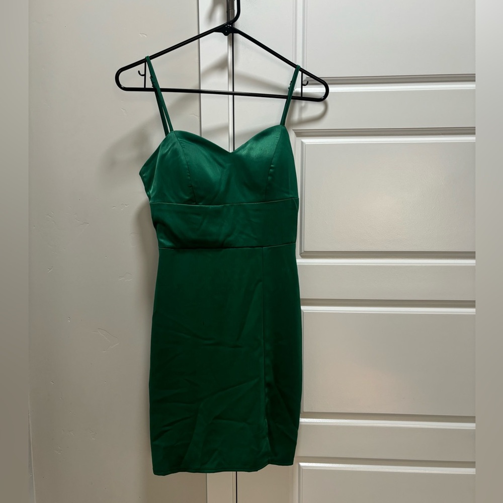 Emerald green tight dress with small leg slit.